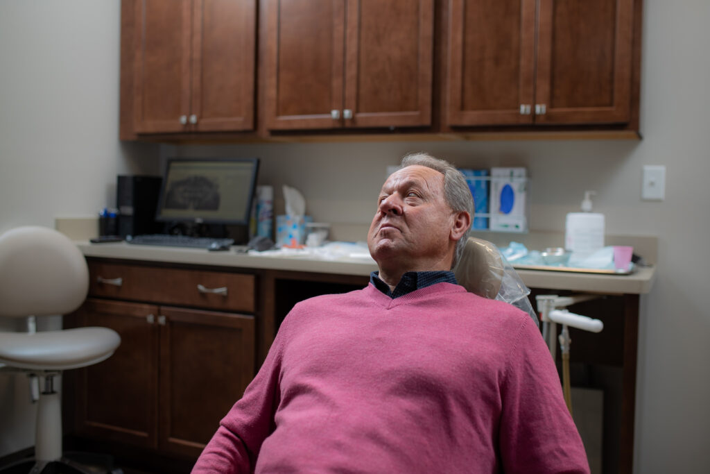 patient sitting in a dental chair receiving post operative instructions for jaw surgery