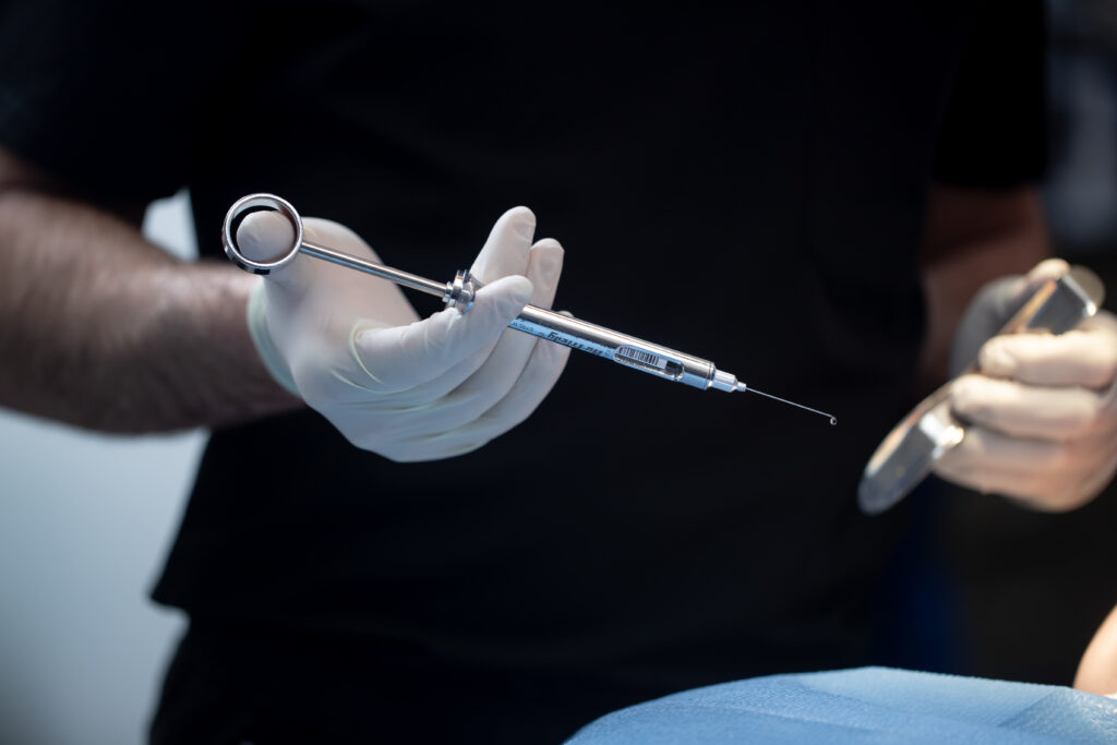 doctor holding tools prepared for general anesthesia and dental surgery