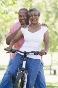 smiling couple on a bike